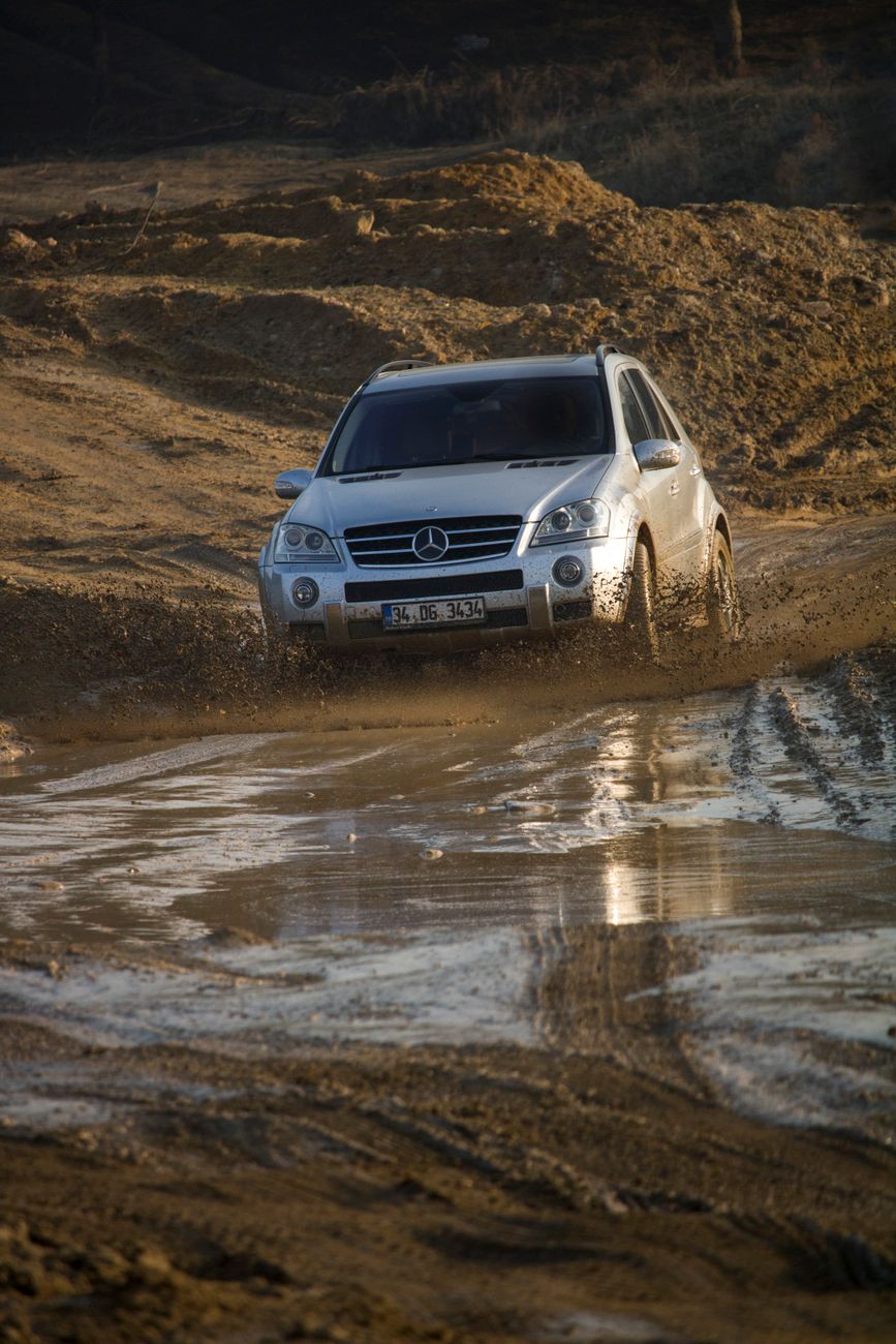 A silver SUV driving through a muddy track in Istanbul, Türkiye, showcasing off-road capabilities.