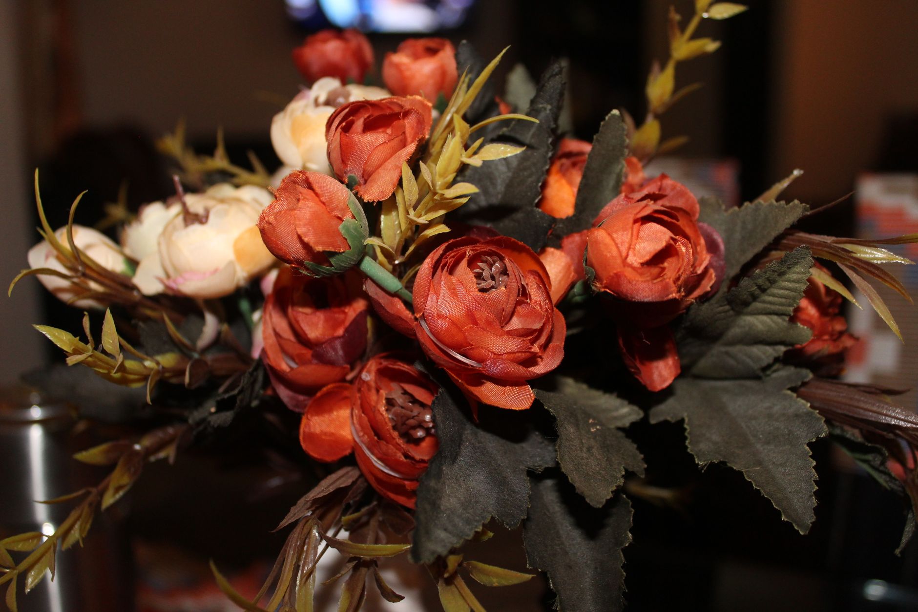 Close-up of a vibrant artificial flower bouquet with rich colors and textures.
