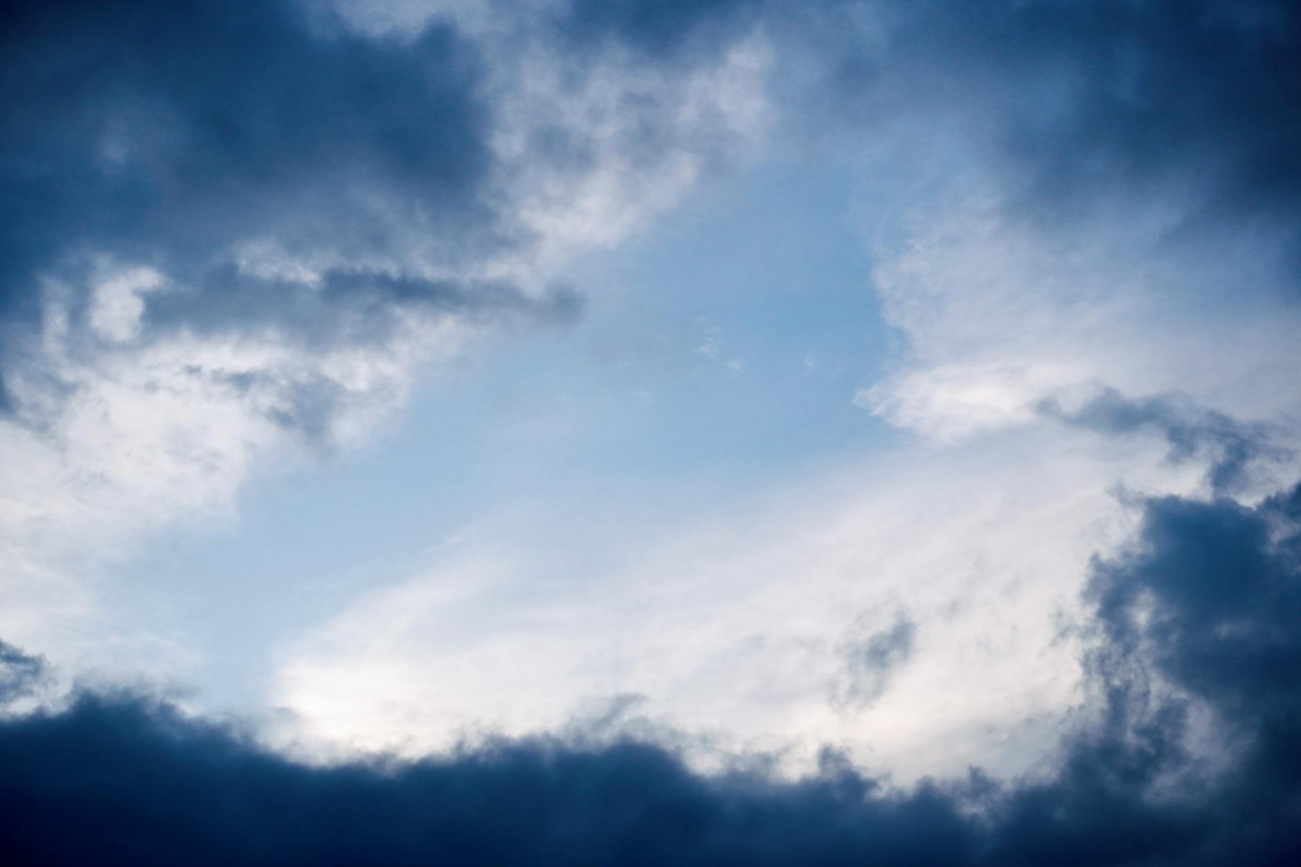 A dramatic cloudy sky in Hyderabad, capturing a moment of contrast between dark and light clouds.