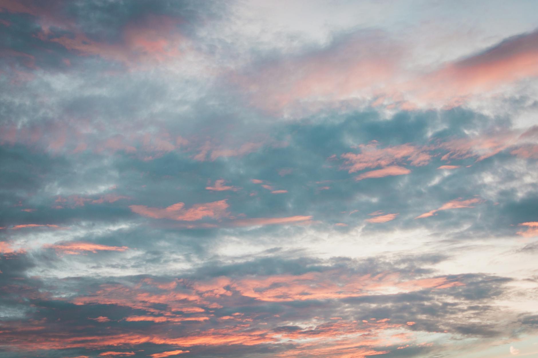 Vibrant sky with pink and blue clouds at sunset, perfect for backgrounds.