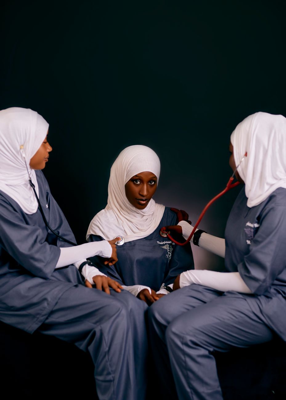 Three female healthcare professionals in uniforms with stethoscope. Medical setting.