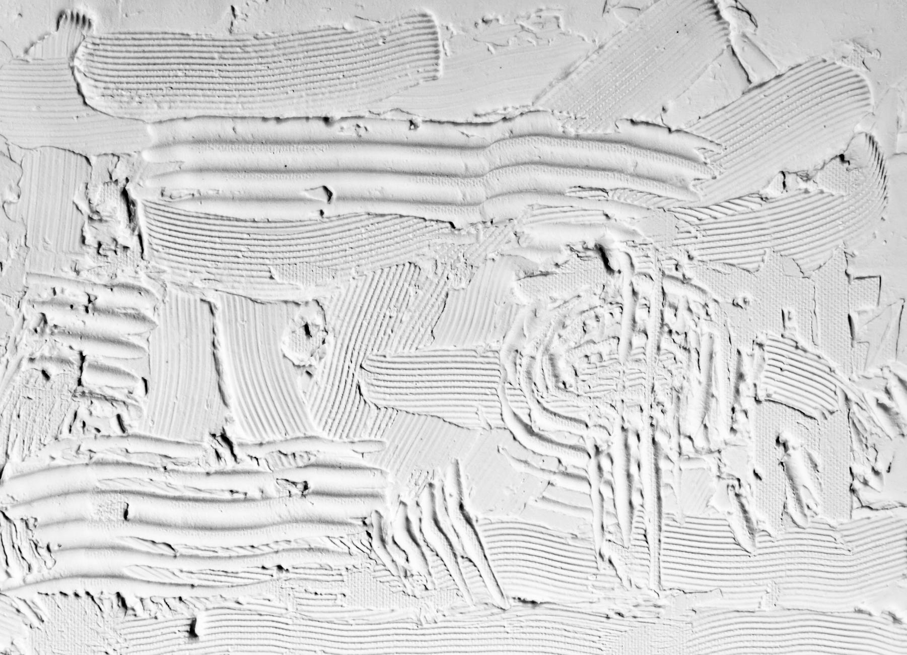 Close-up of textured white plaster with artistic strokes, perfect for minimalist backgrounds.