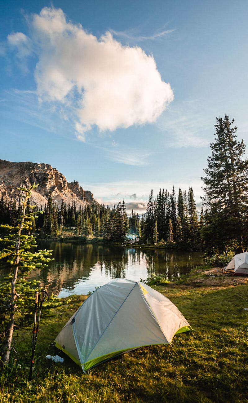Scenic camping spot beside a reflective mountain lake in British Columbia, Canada.