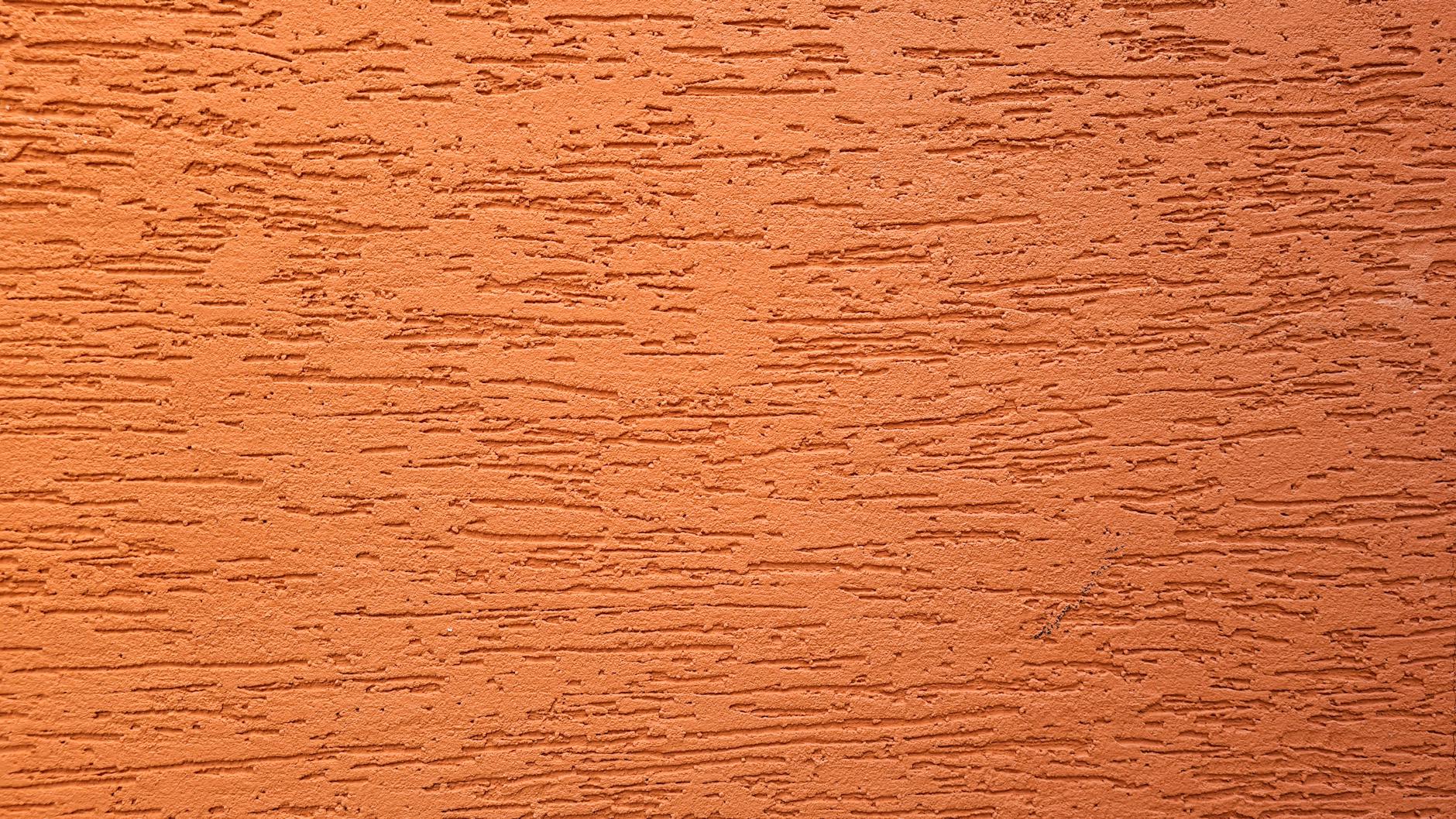 Close-up of an orange textured wall surface in Campinas, Brazil, showing a rough pattern.