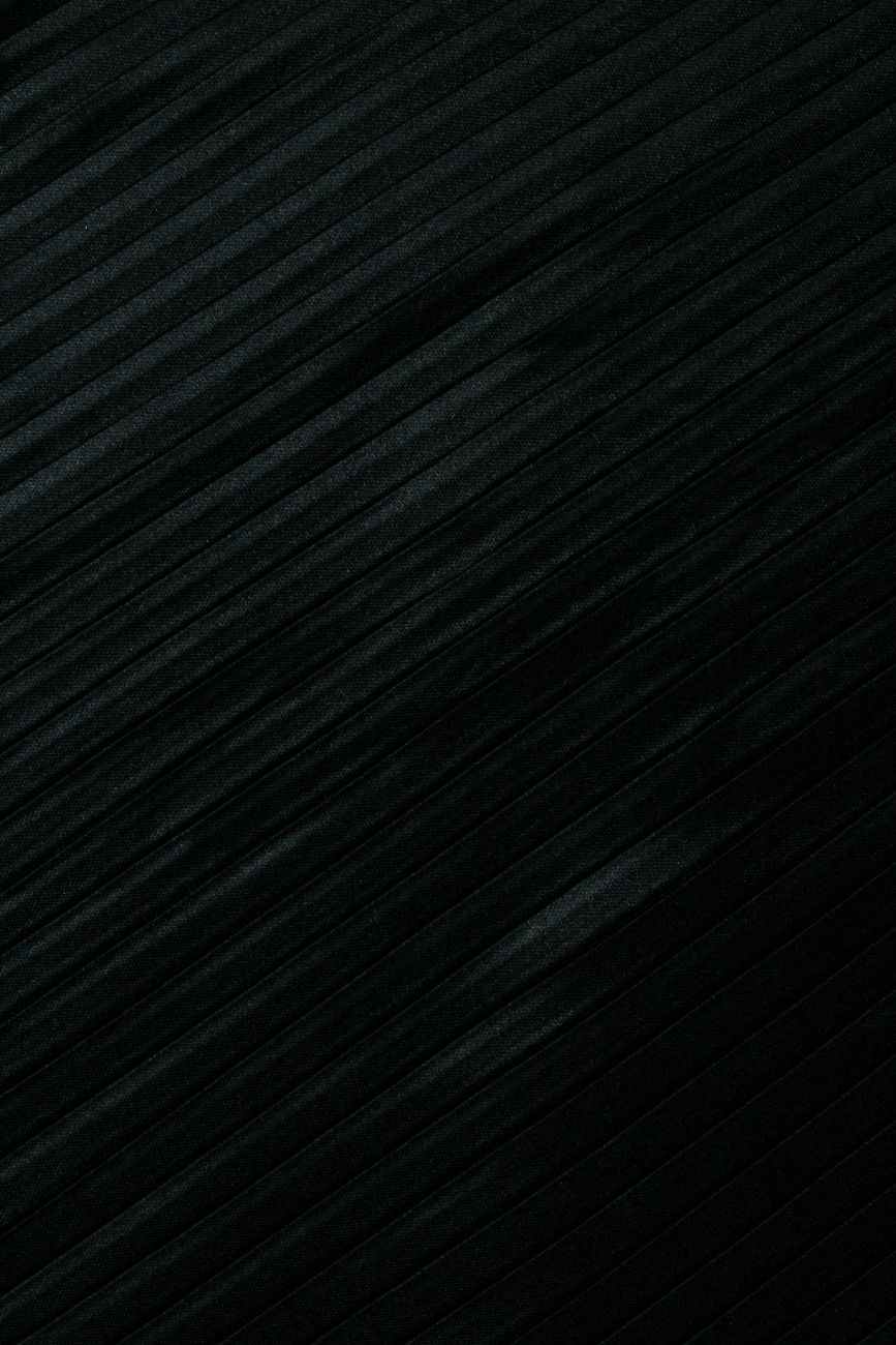 A close-up view of an elegant black textured fabric surface with diagonal lines, perfect for backgrounds.