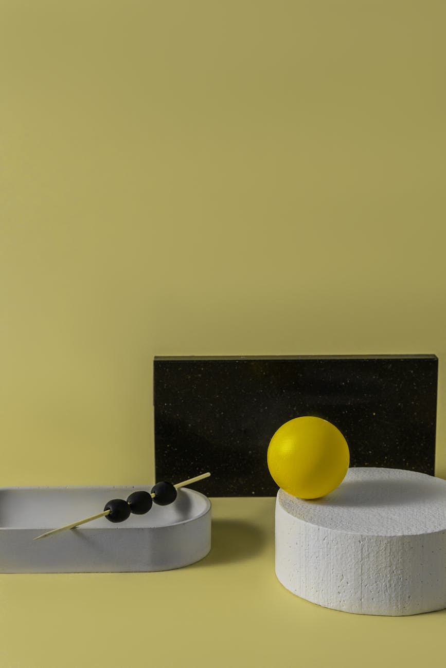 A minimalist arrangement of geometric shapes featuring bold yellow and black accents, perfect for contemporary design concepts.