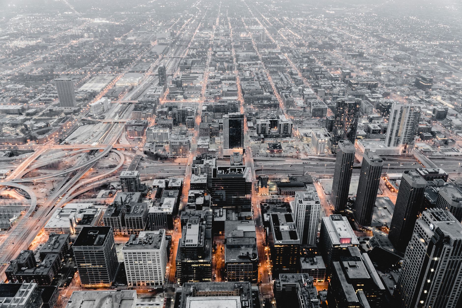 Stunning aerial cityscape of Chicago showcasing its urban structure and illuminated streets at dusk.