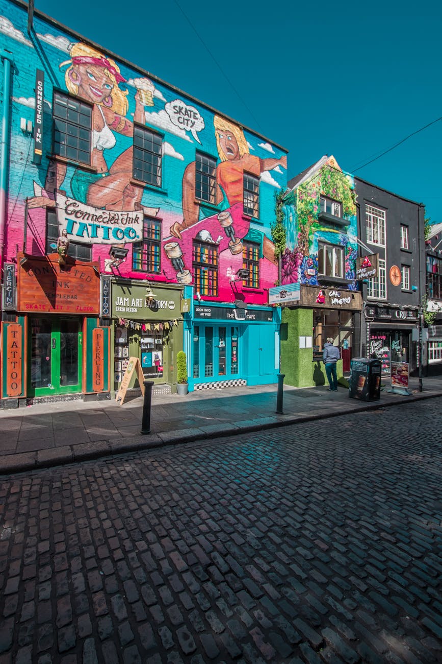 Vibrant street art and shops in a lively Dublin city street.