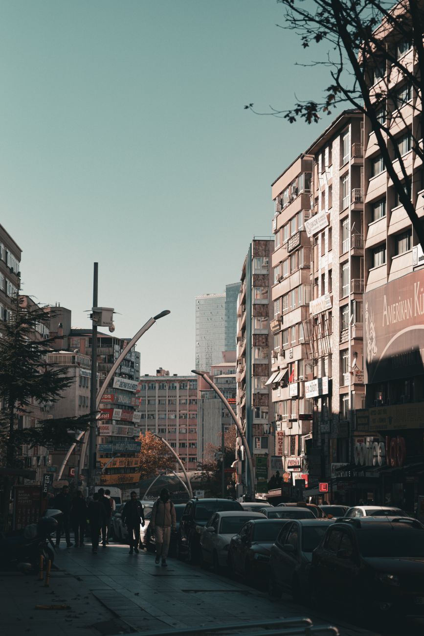 A busy urban street scene with modern buildings and pedestrians in a city setting.