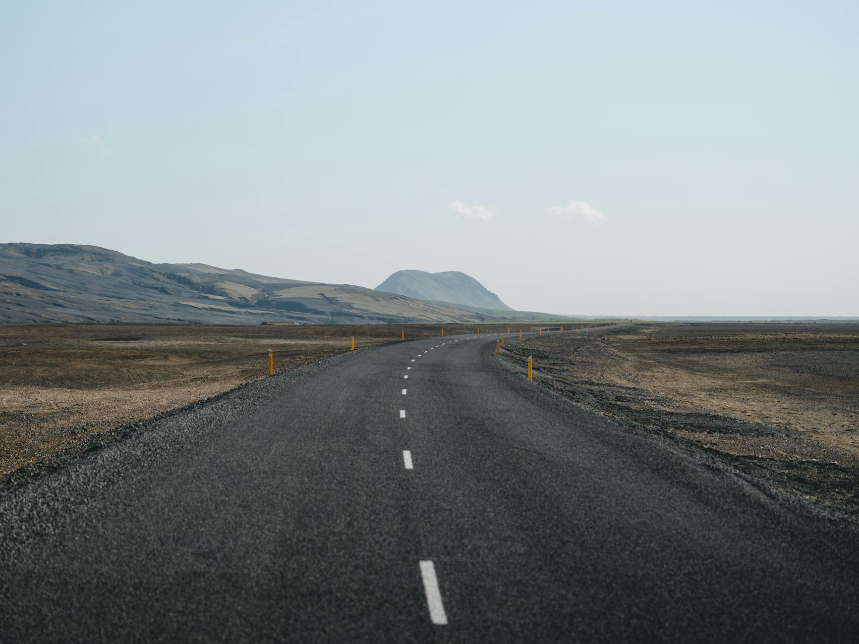 Empty highway stretching through Skagafjörður's dramatic Icelandic landscape.