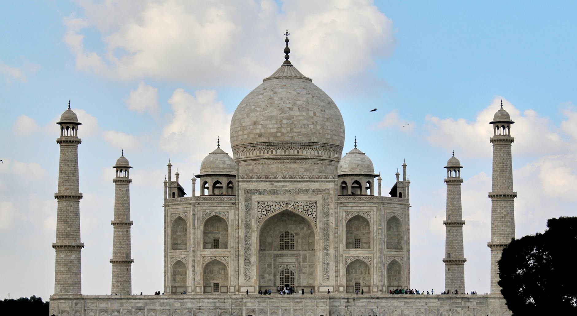 A breathtaking frontal view of the Taj Mahal, Agra, India against a clear blue sky.