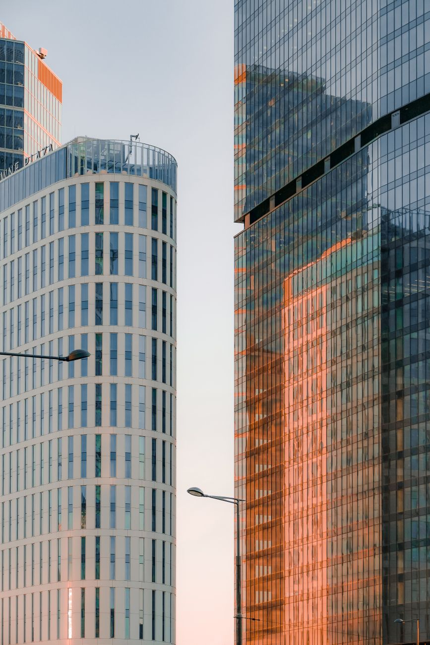 Contemporary skyscrapers reflecting sunlight with urban architectural design.