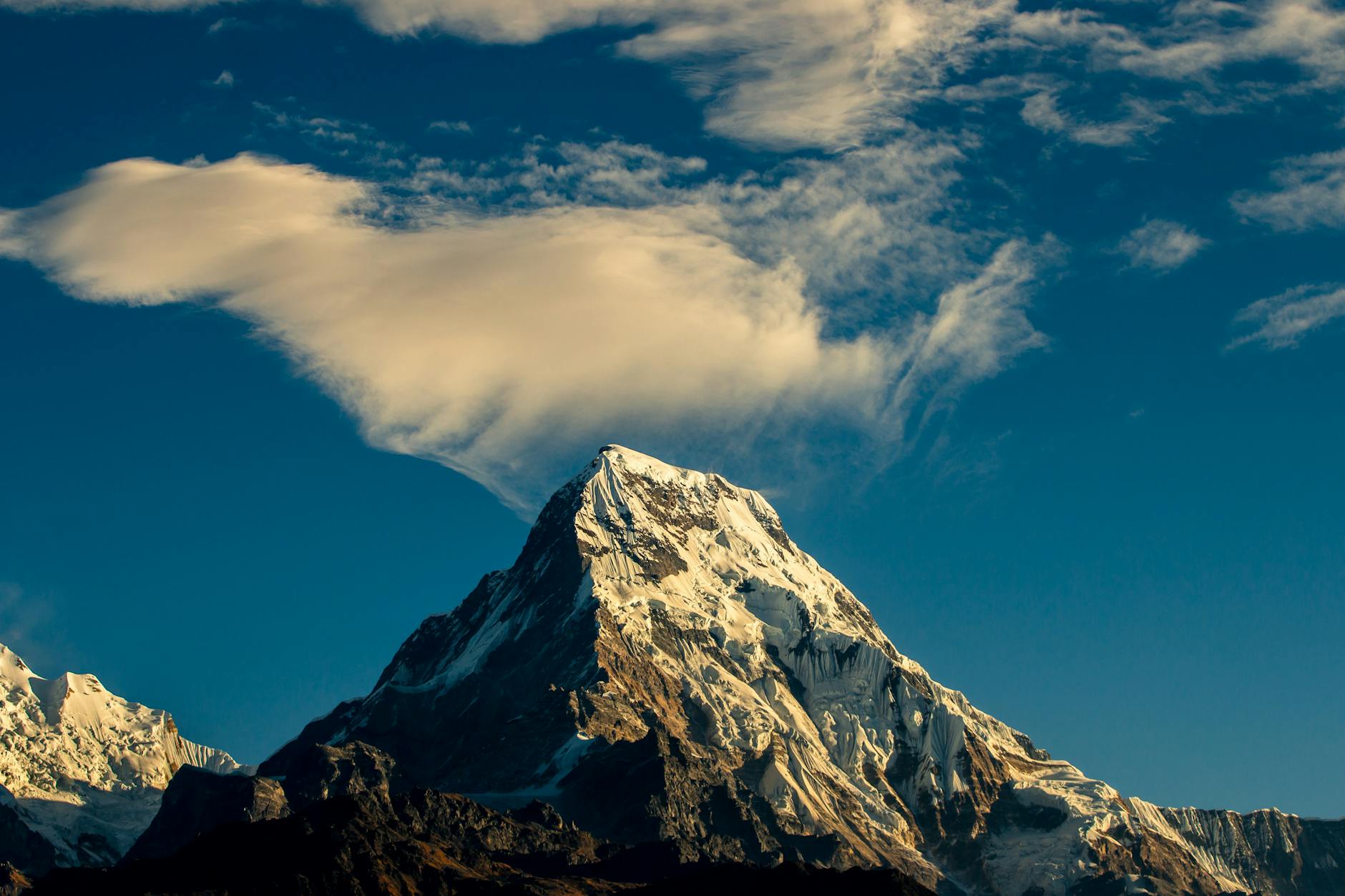 Stunning snow-capped mountain peak under a vibrant sky, perfect for nature lovers.