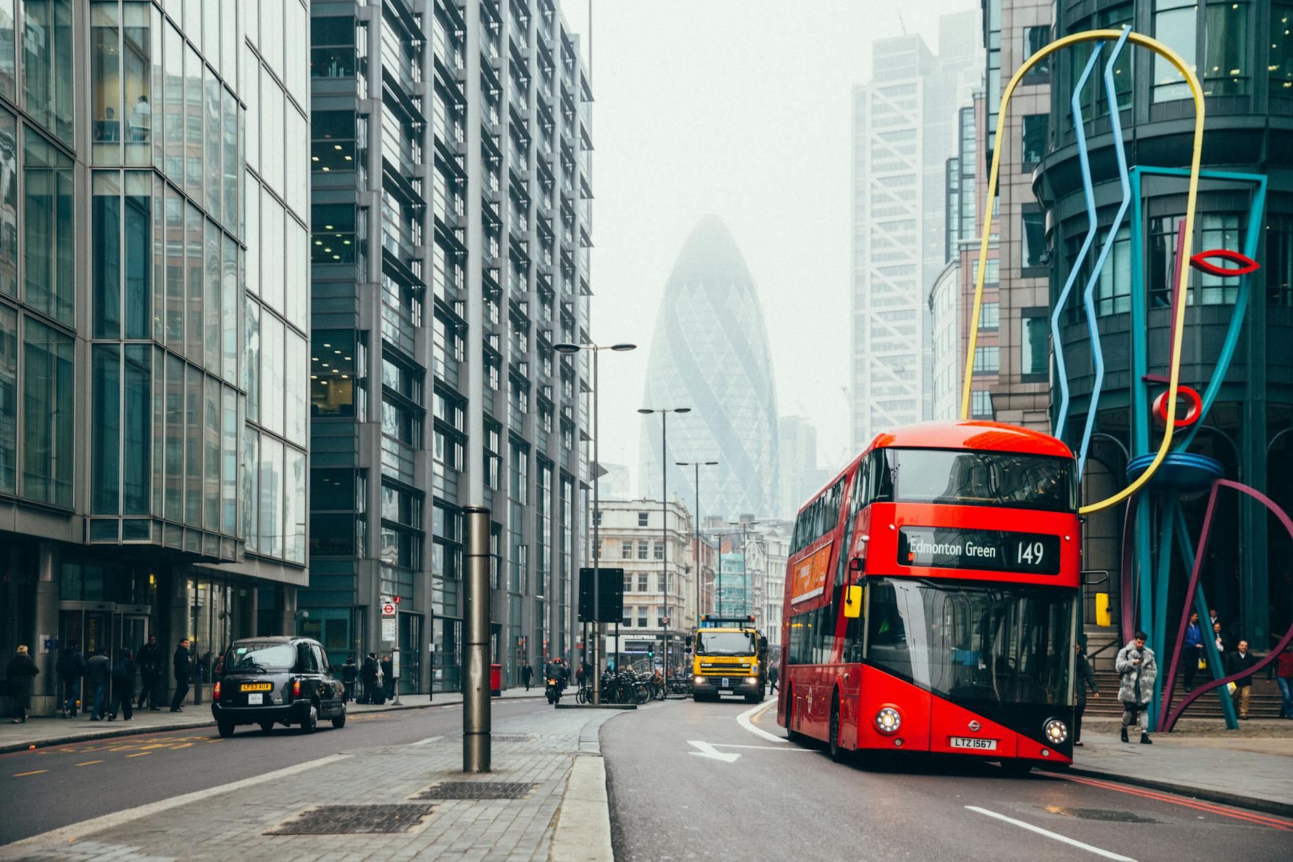 Capture of London street scene featuring a red double-decker bus. Iconic city architecture.