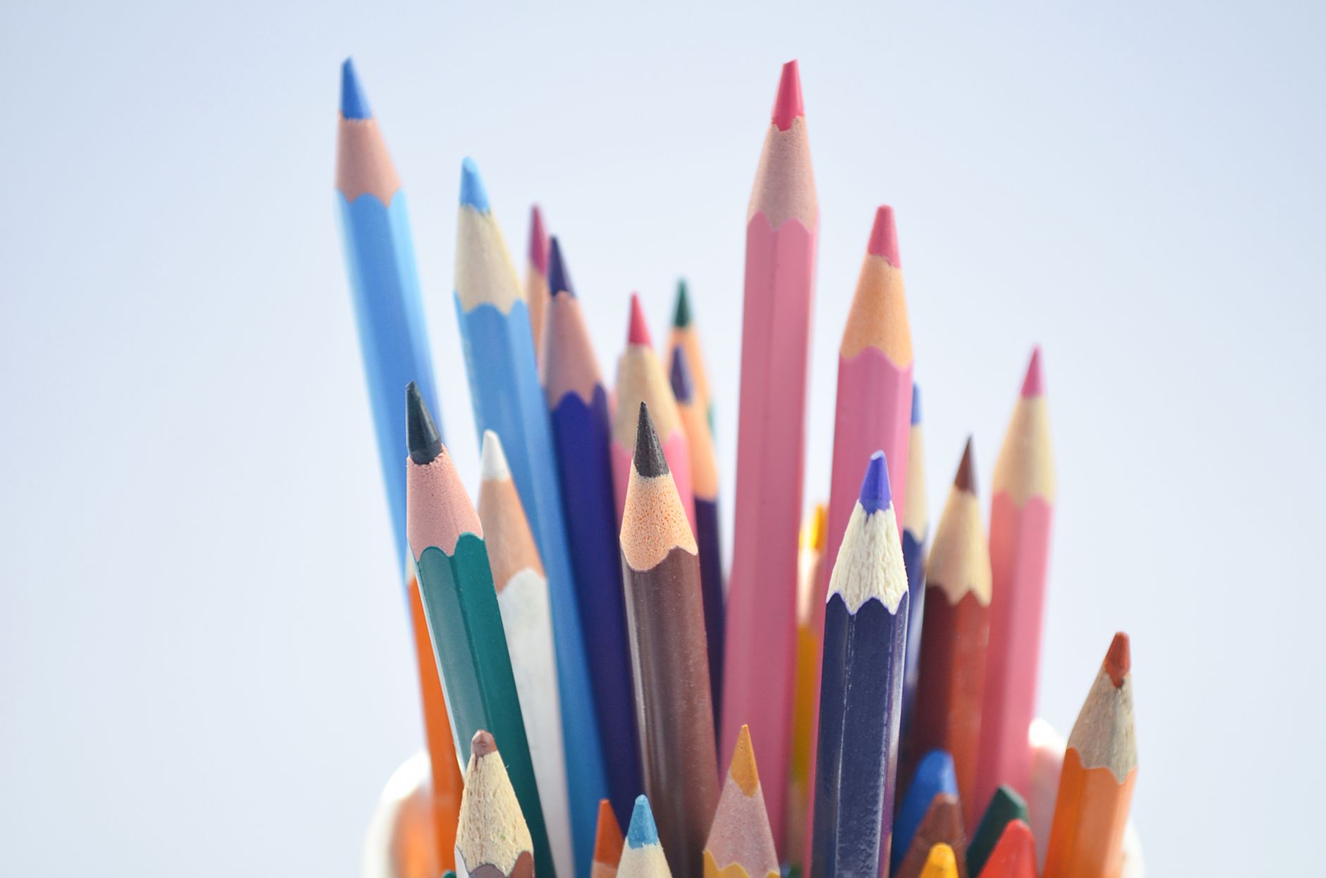 A close-up shot of a variety of colorful pencils in a container, ideal for creative projects.