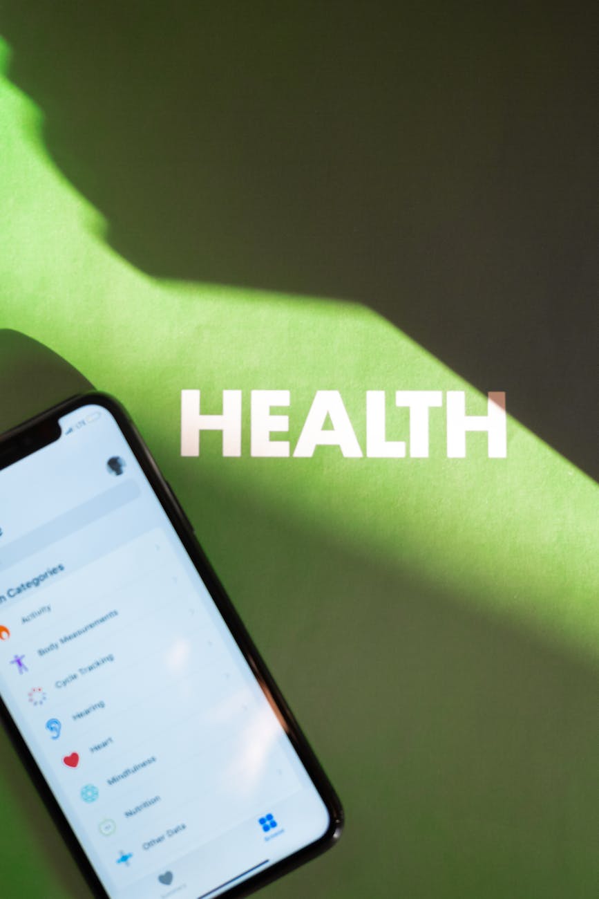 Smartphone displaying health app under light and shadow on a green background.