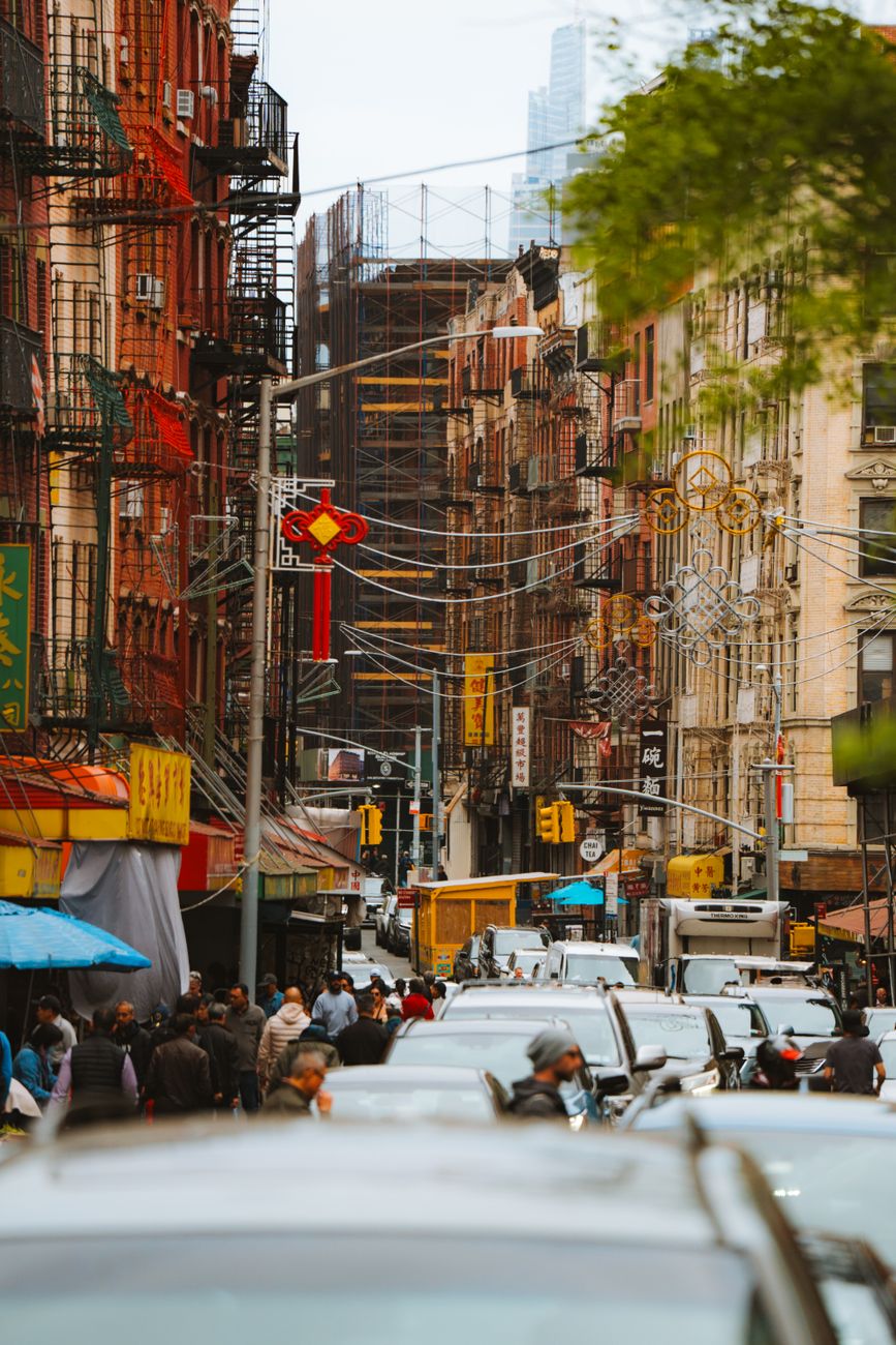 A crowded city street scene in Chinatown capturing vibrant urban life and architecture.