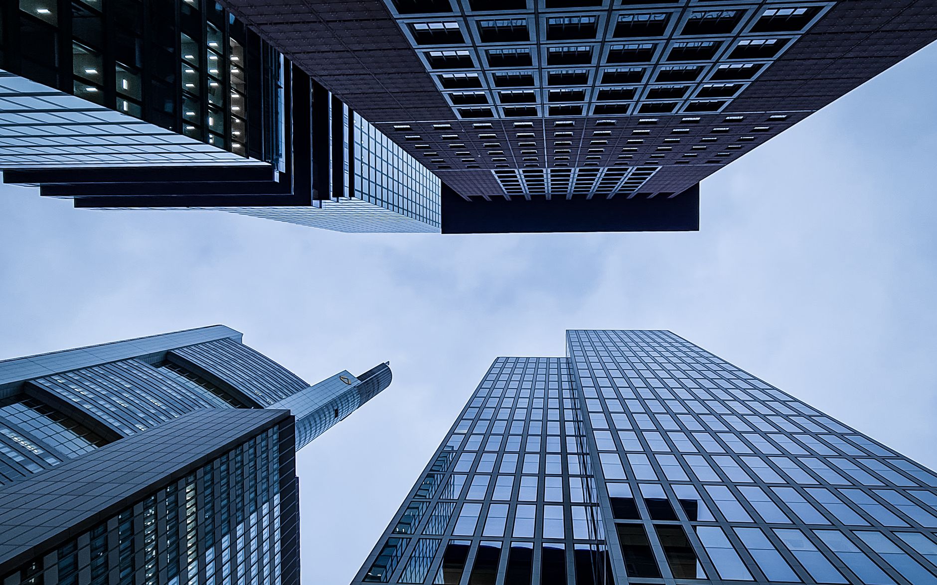 Low angle view of major skyscrapers in Frankfurt, Germany, showcasing urban architecture.