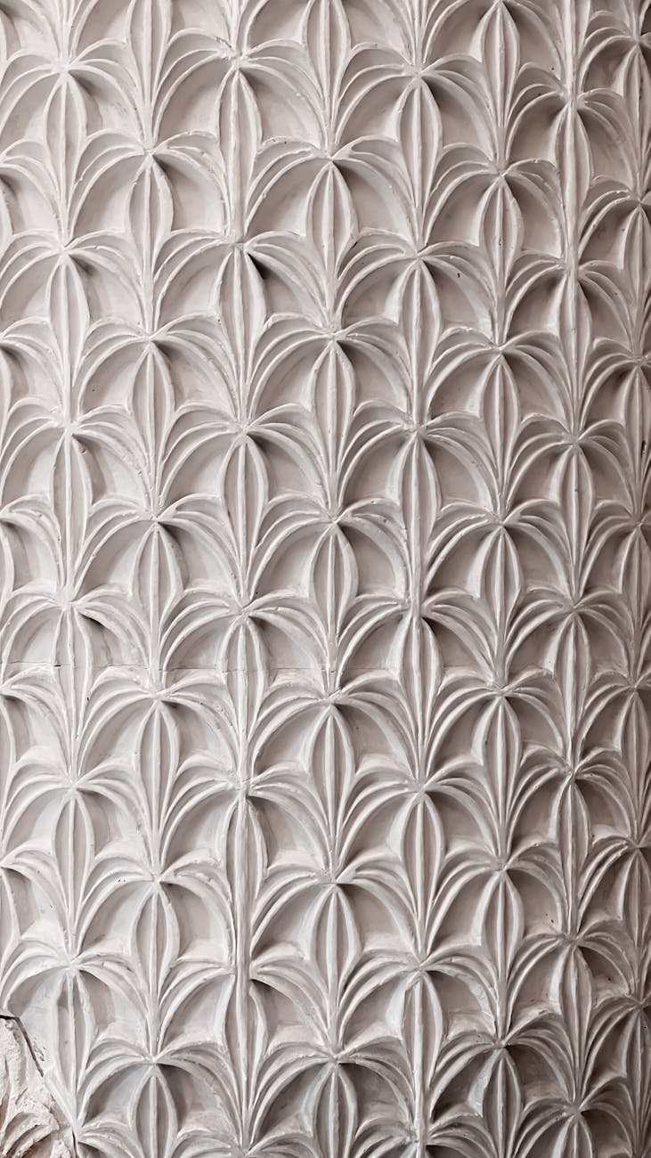 Elegant repeating floral pattern on architectural surface, capturing historic design.