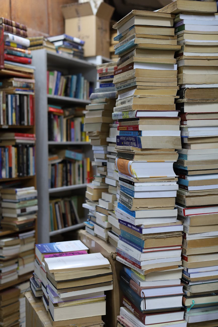 A densely packed room filled with towering stacks of books, conveying a love for literature and knowledge.