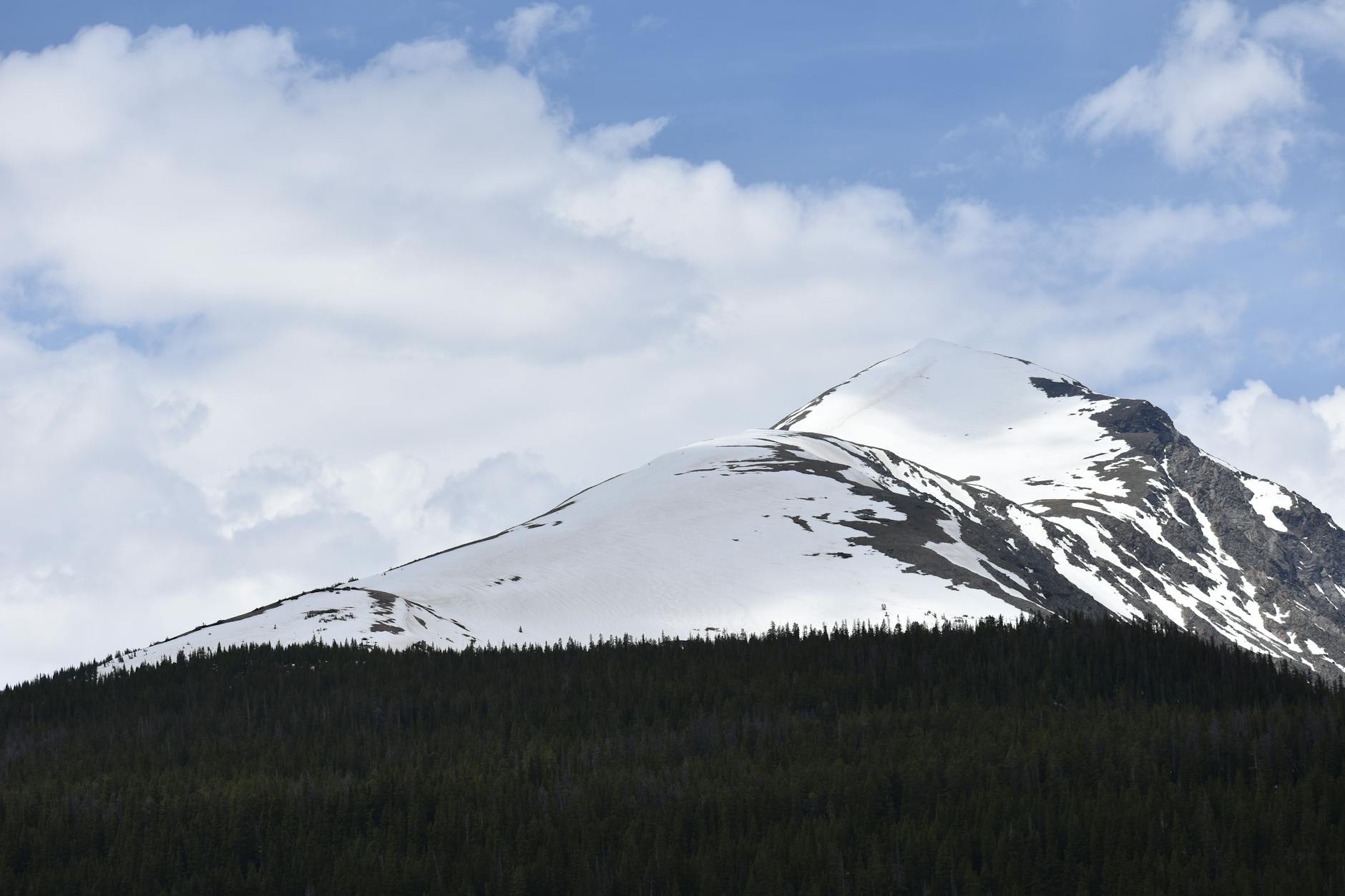 Stunning snow-capped mountain peaks under a vibrant sky in Colorado.