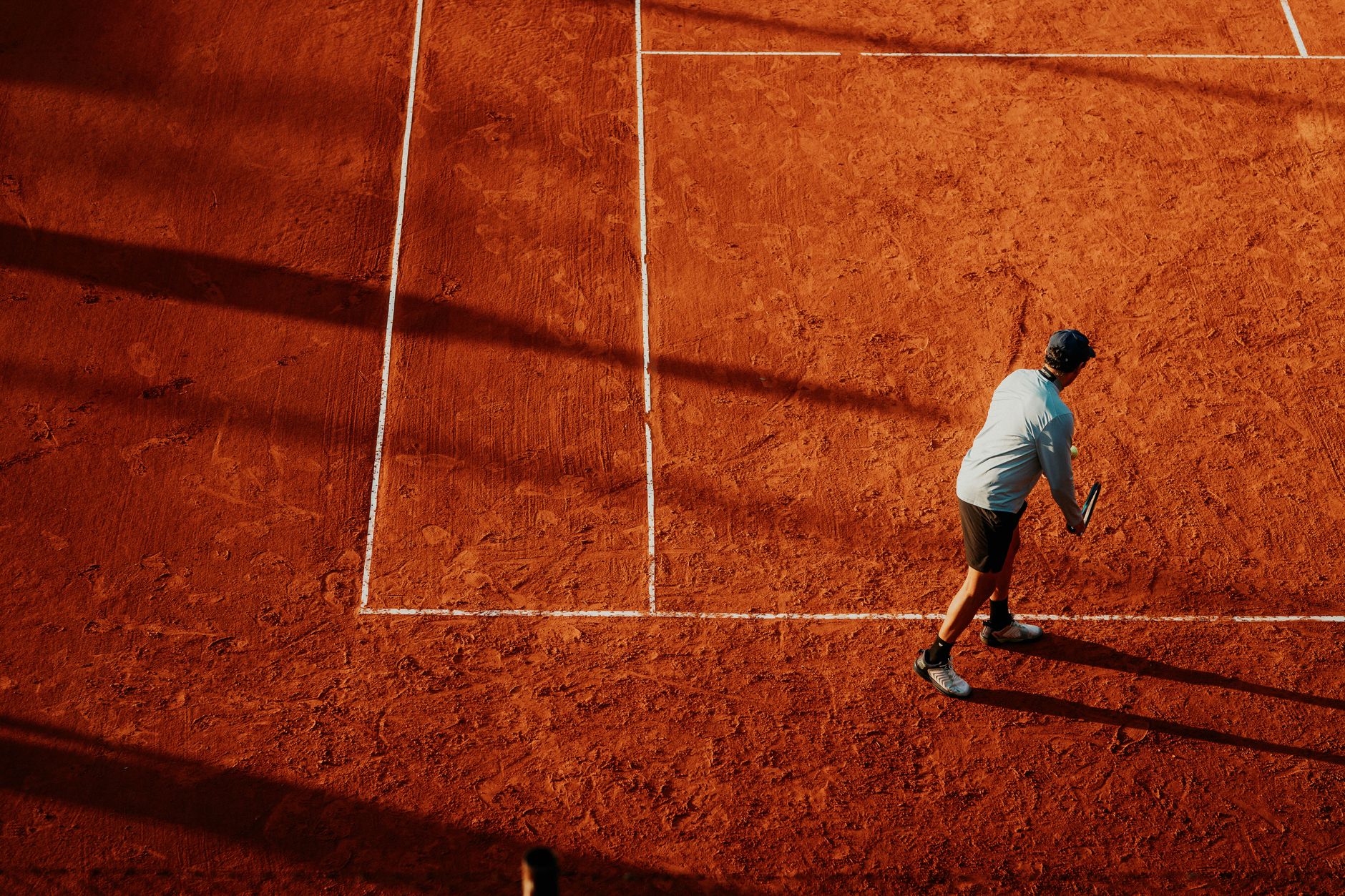 Tennis player preparing to serve on a clay court in Buenos Aires, Argentina.