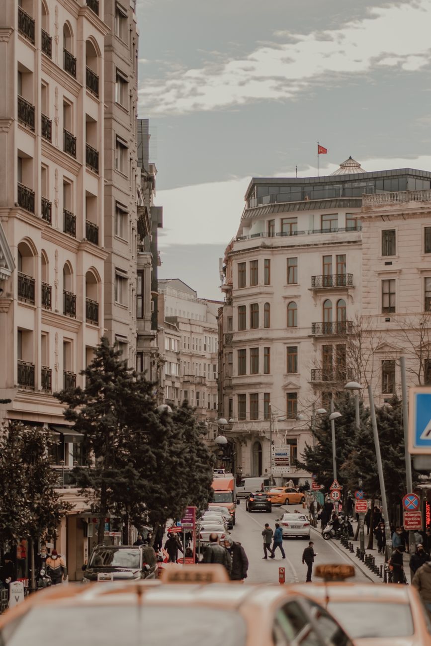 Urban scene in Istanbul with buildings, cars, and people on a busy street. Captivating city life in Turkey.