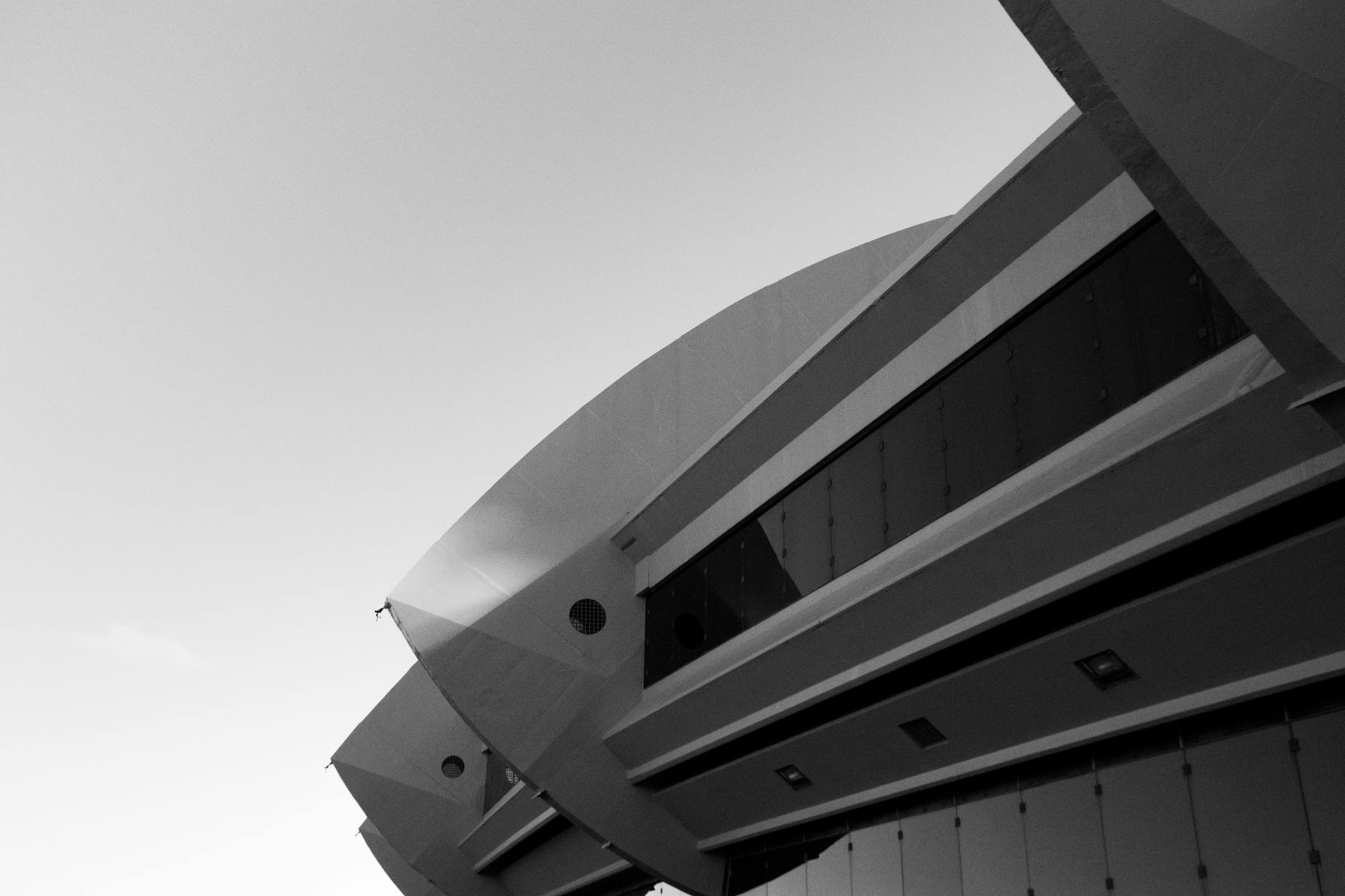 Dynamic black and white photo showcasing a modern architectural facade in Montreal's urban landscape.