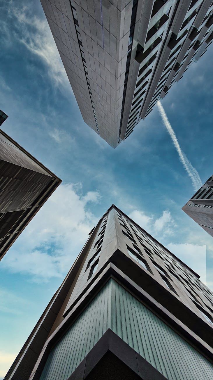 Capture of towering skyscrapers against a blue sky in Manchester, UK.