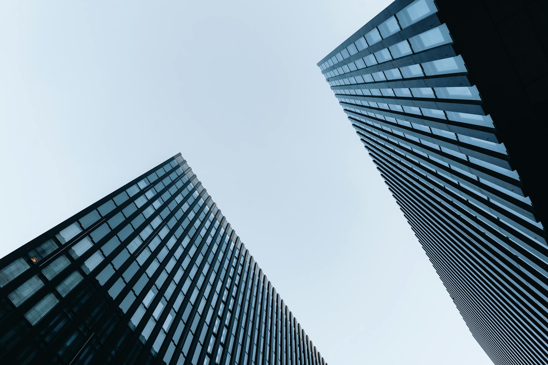 A view of sleek modern skyscrapers against a clear blue sky, showcasing urban architecture.