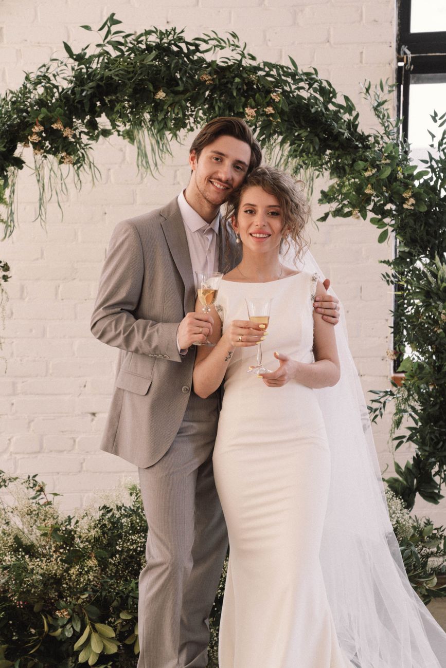 Charming couple celebrating their wedding day indoors with elegance and joy.