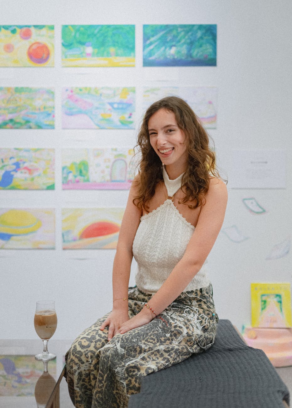 Woman enjoying art exhibition in Shinjuku, Tokyo, with colorful paintings.