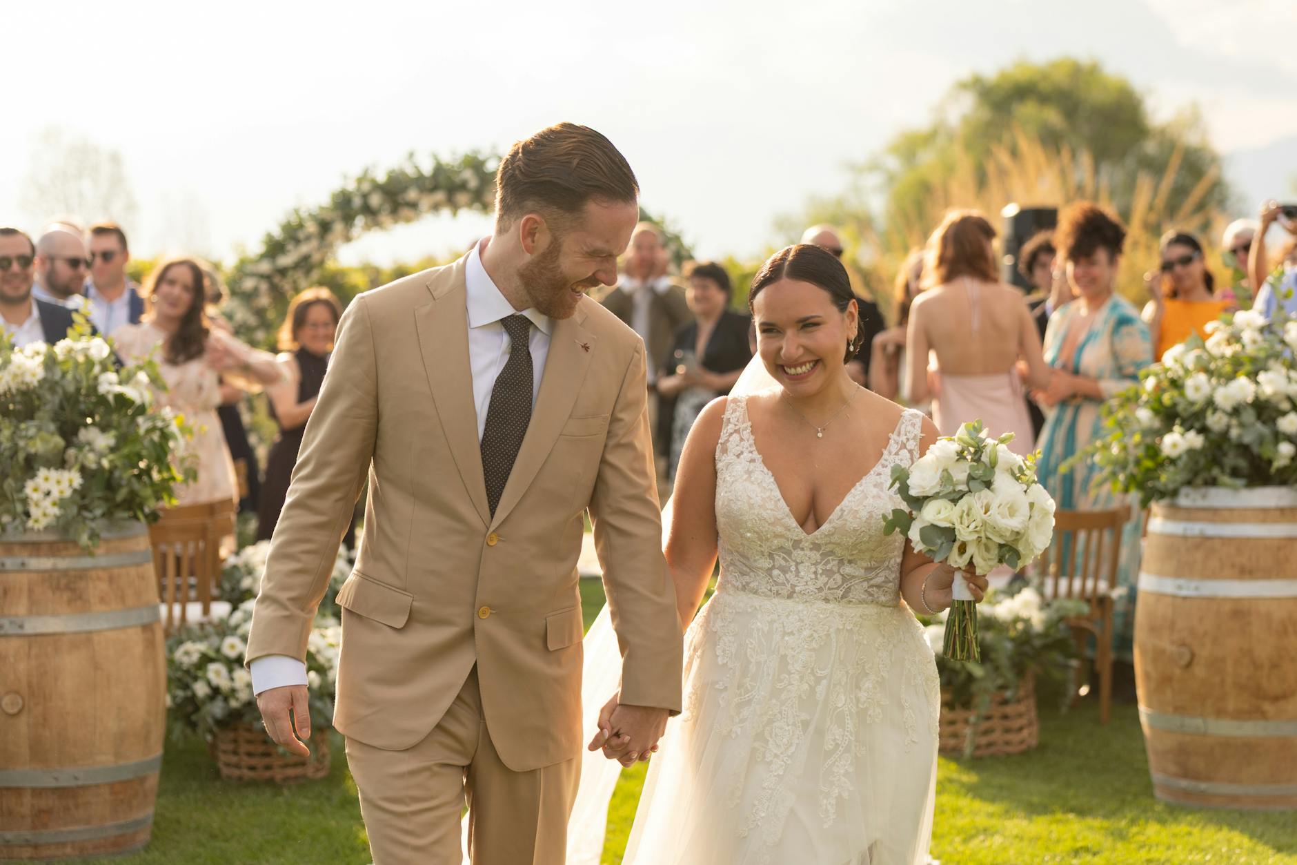 Bride and groom walk joyfully after ceremony in Mendoza, Argentina.