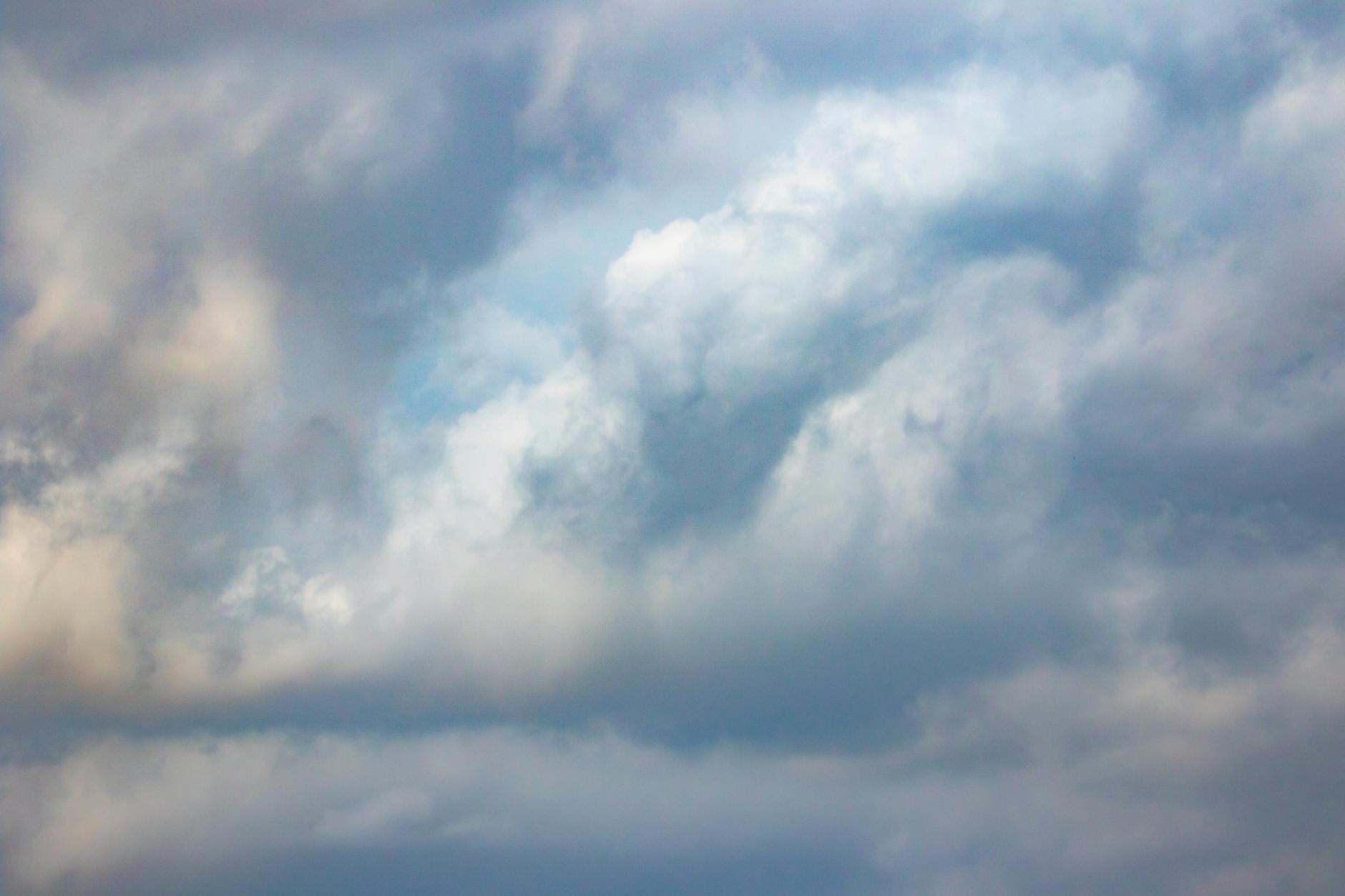 A peaceful cloudy sky with soft light and textures, perfect for weather and nature themes.