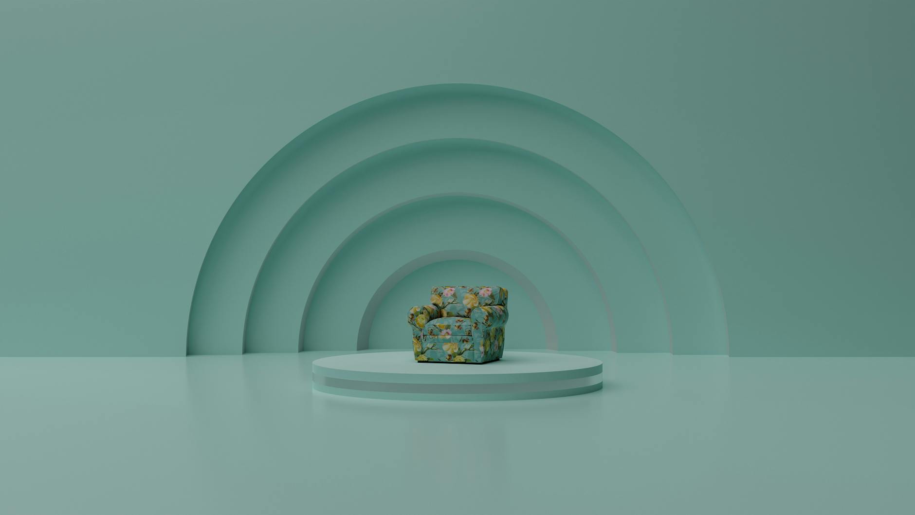 Floral chair on a platform in a minimalist turquoise space.