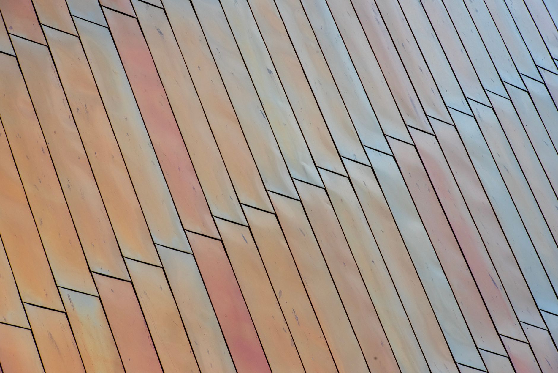 Close-up abstract view of wooden panels arranged in a zigzag pattern with a warm color tone.