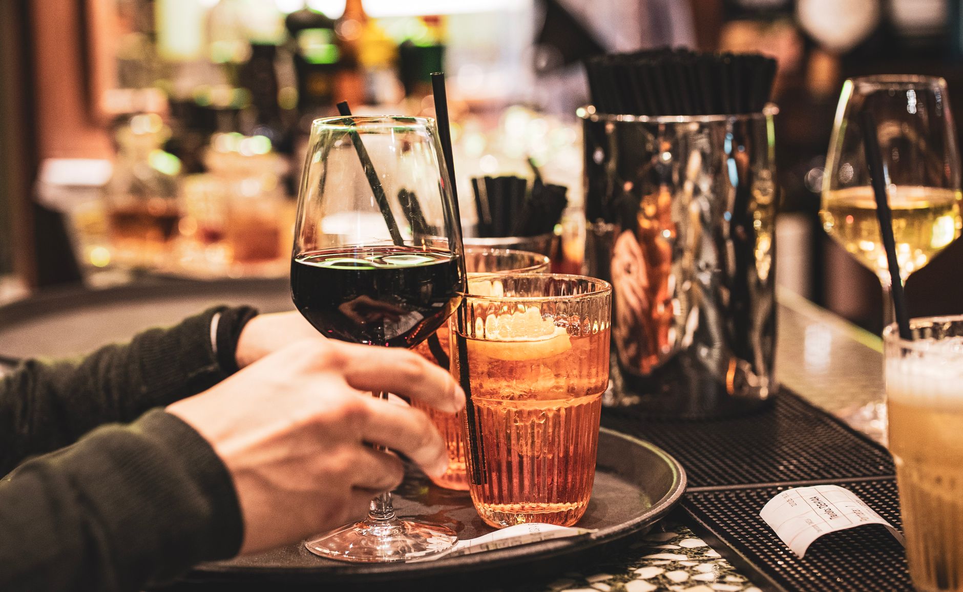 A vibrant scene of drinks including spritz and wine at a Milan bar, capturing Italian nightlife.