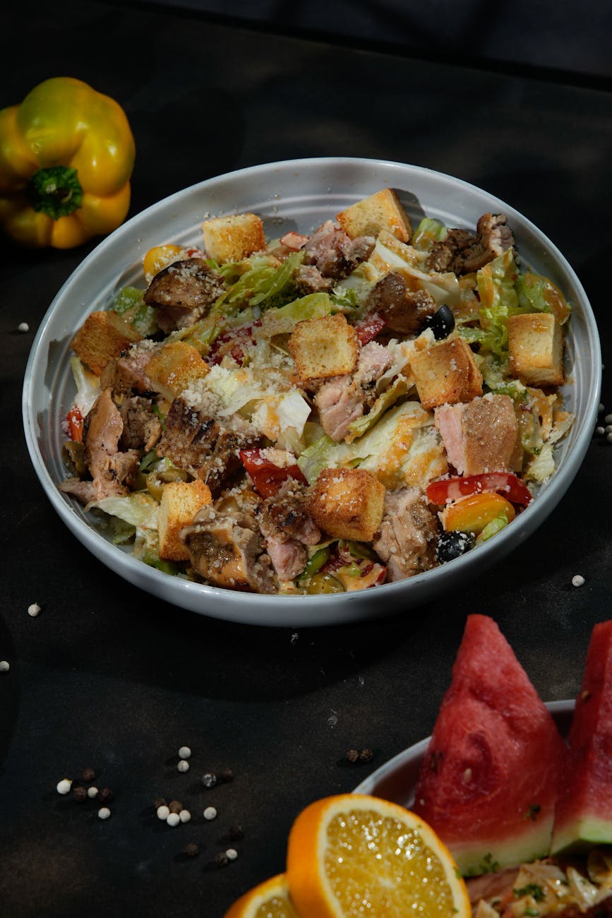 Vibrant grilled chicken Caesar salad with croutons, peppers, and cheese.