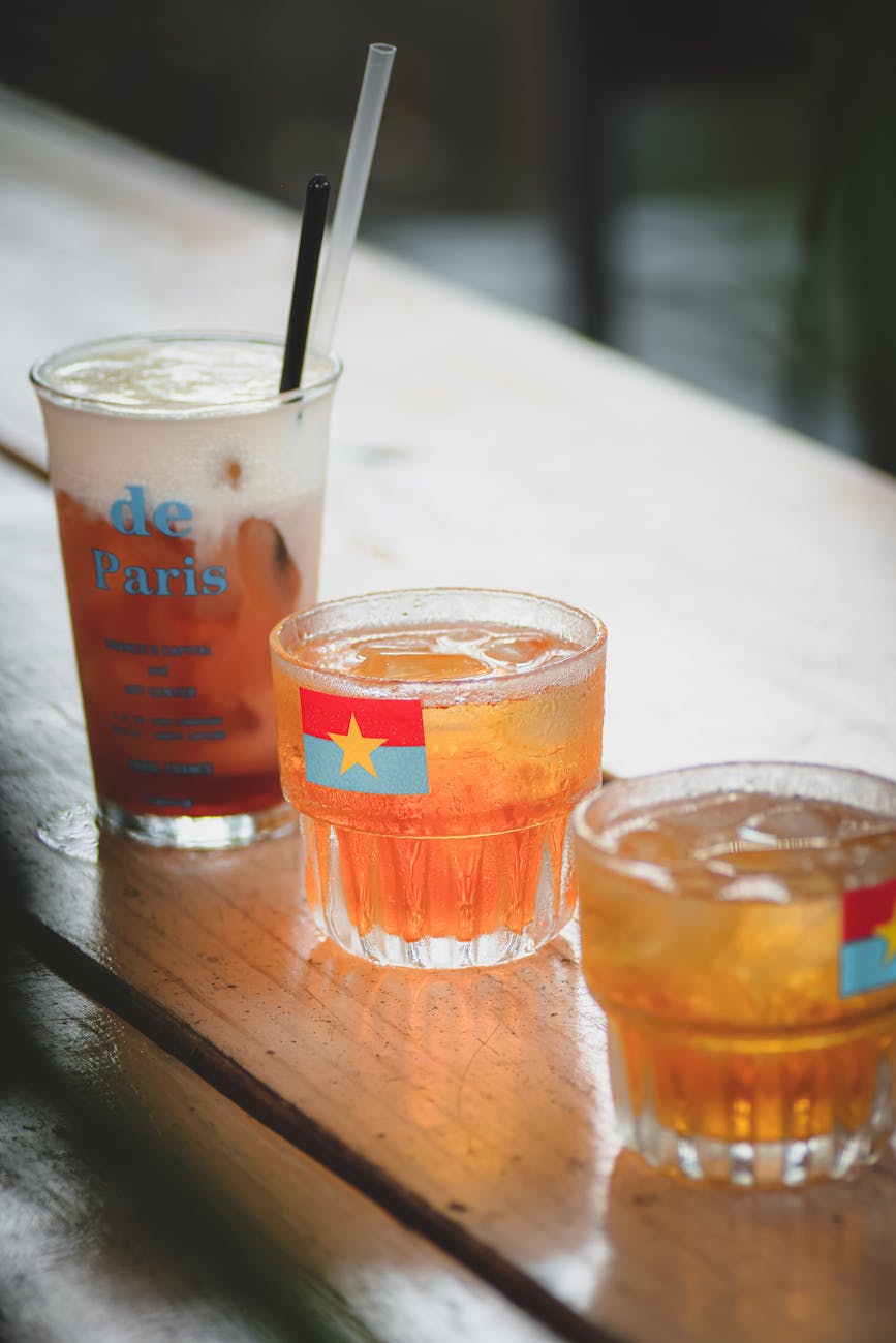 Three delicious drinks with ice on a table, perfect for summer refreshment.