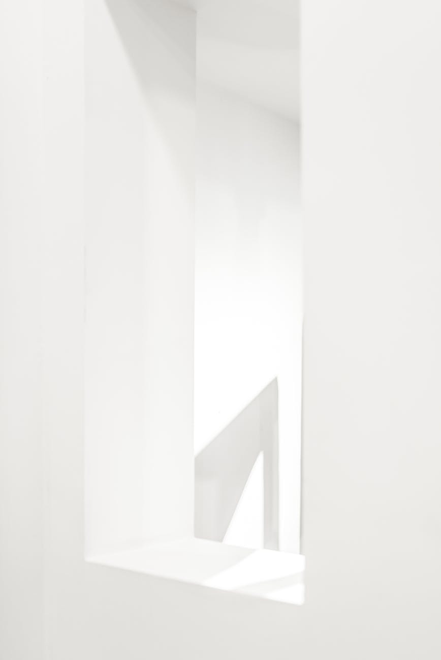 A minimalist abstract white interior space showcasing clean lines and modern architecture.