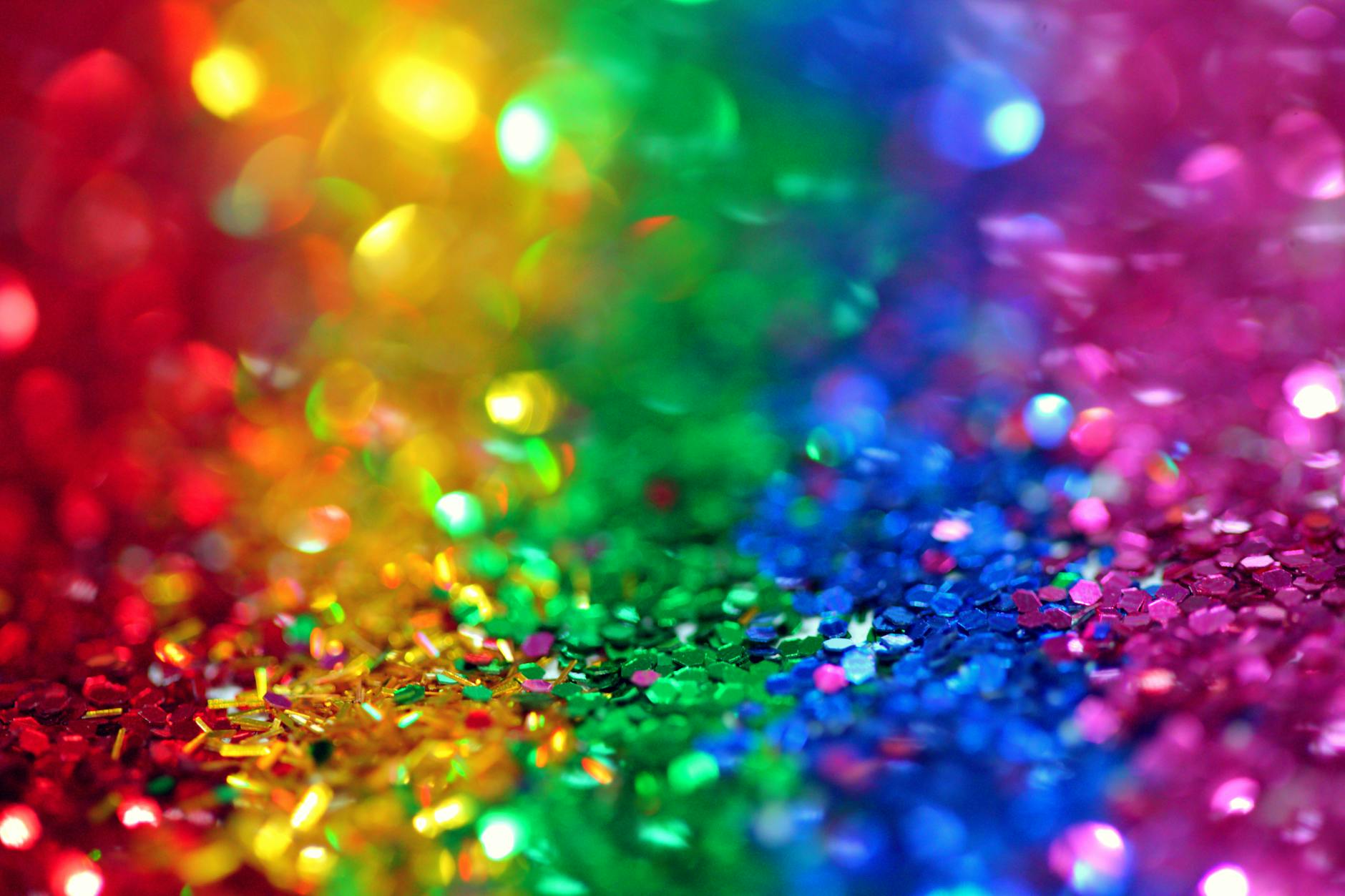 Colorful bokeh effect with vibrant rainbow glitter, perfect for festive backgrounds.