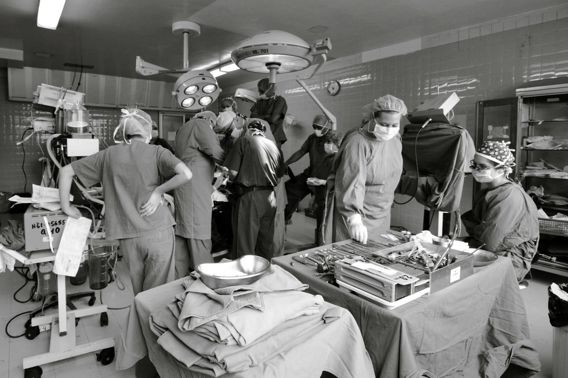 Surgical team in action in a hospital operating room, showcasing teamwork and precision.
