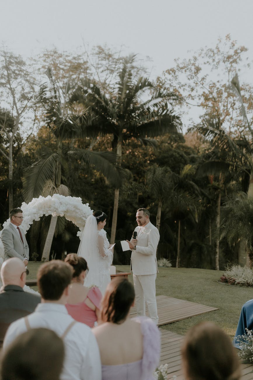 A beautiful outdoor wedding ceremony with bride and groom in tropical surroundings.