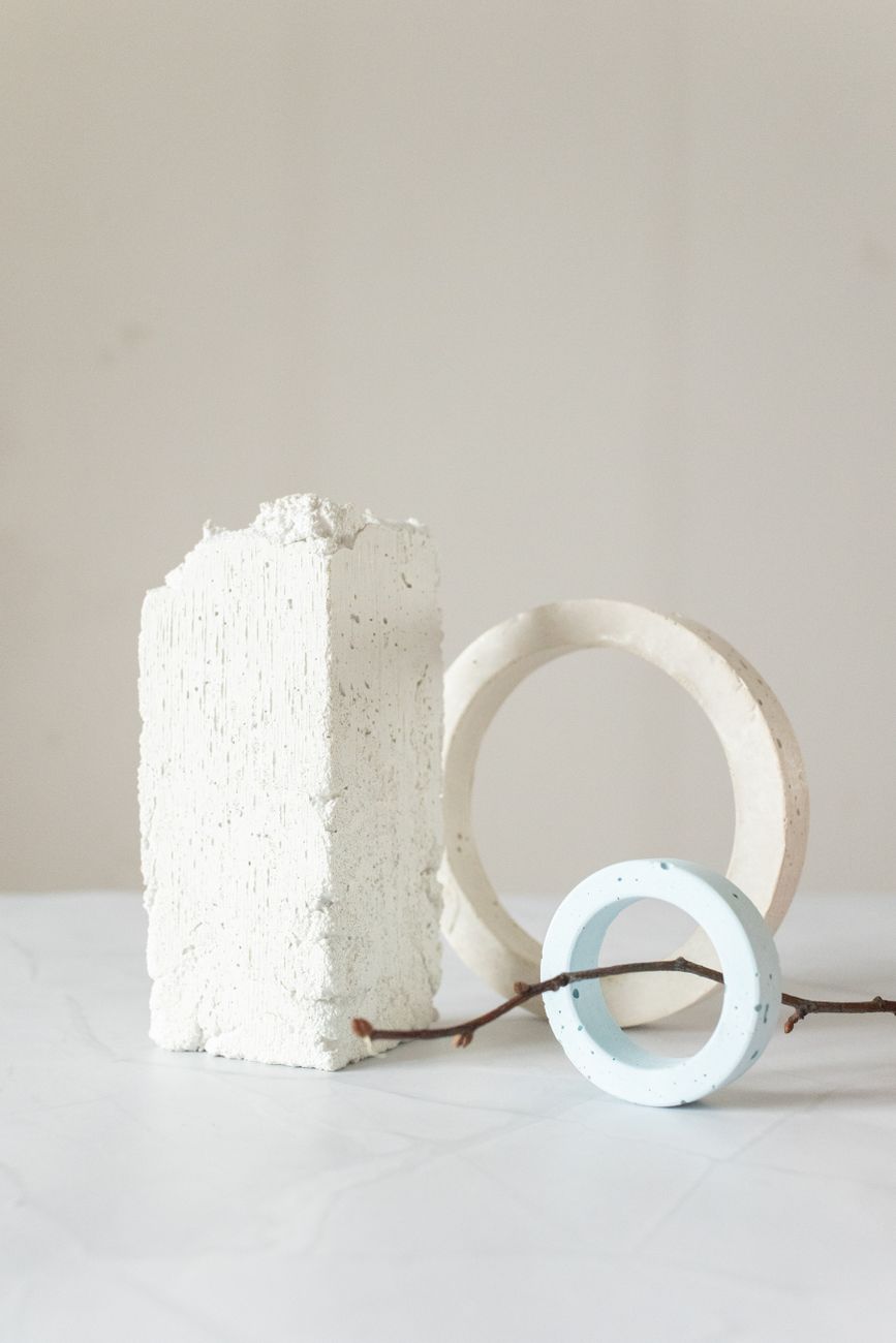 A minimalist composition featuring geometric shapes and a twig, exhibiting simplicity and balance.