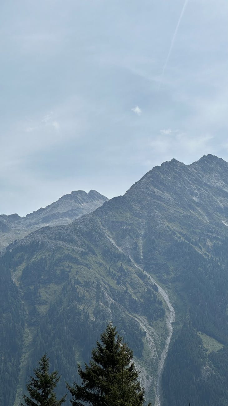 Breathtaking view of the Austrian Alps under a clear blue sky, perfect for nature lovers.