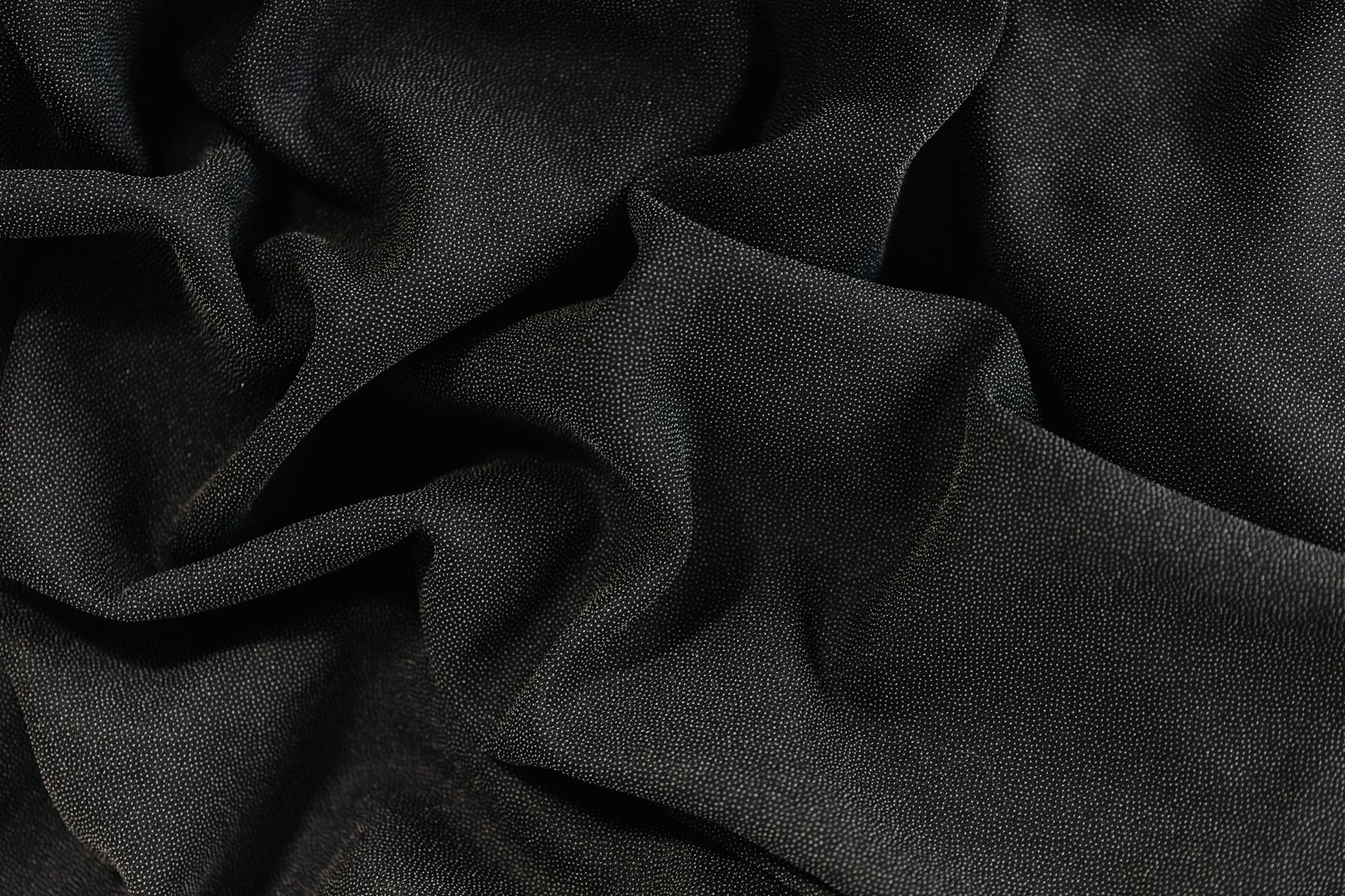 Detailed image showcasing black fabric texture with smooth and fine weave.