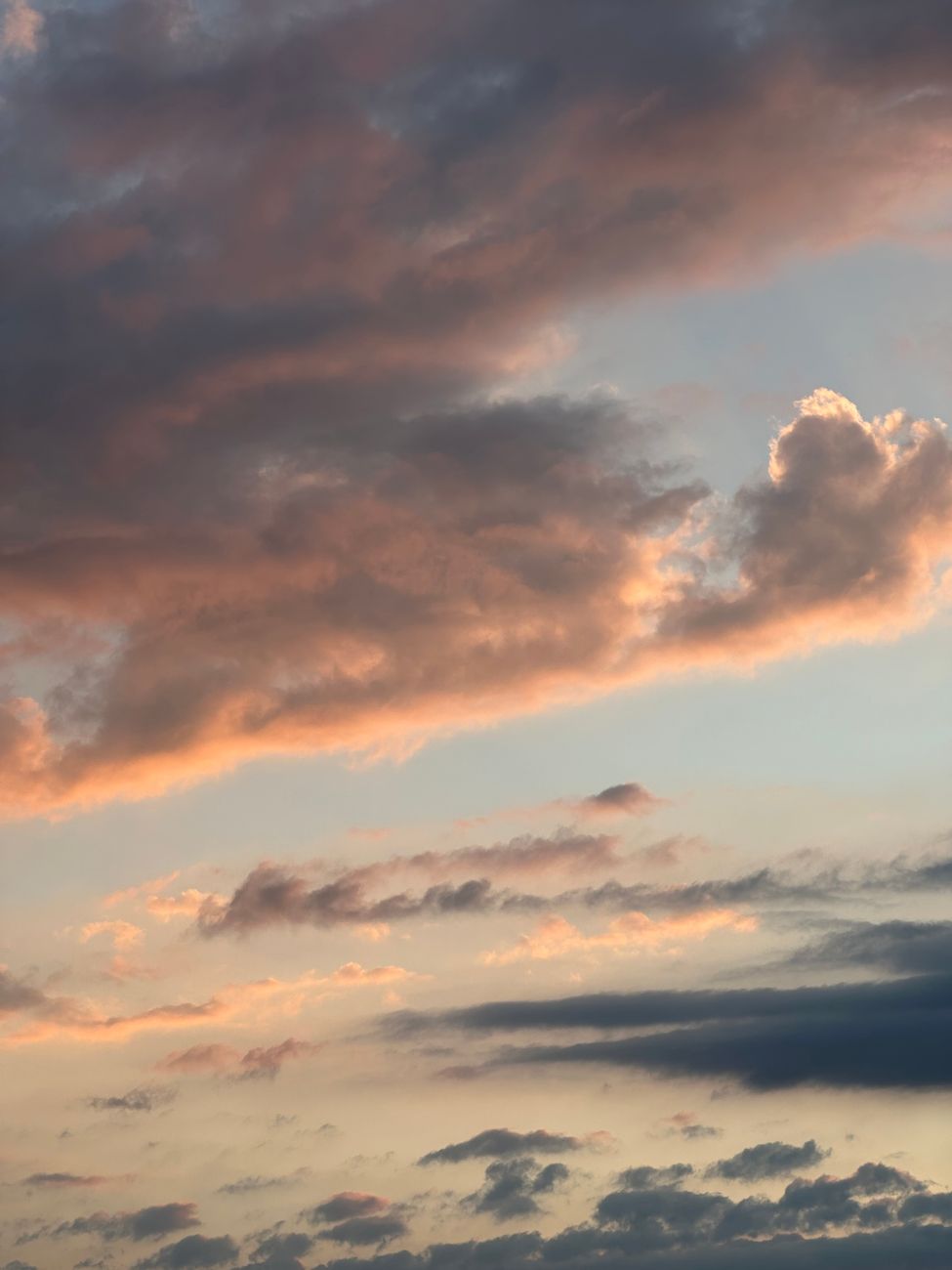 Dramatic sky with vibrant sunset hues and fluffy clouds, creating a serene atmosphere.