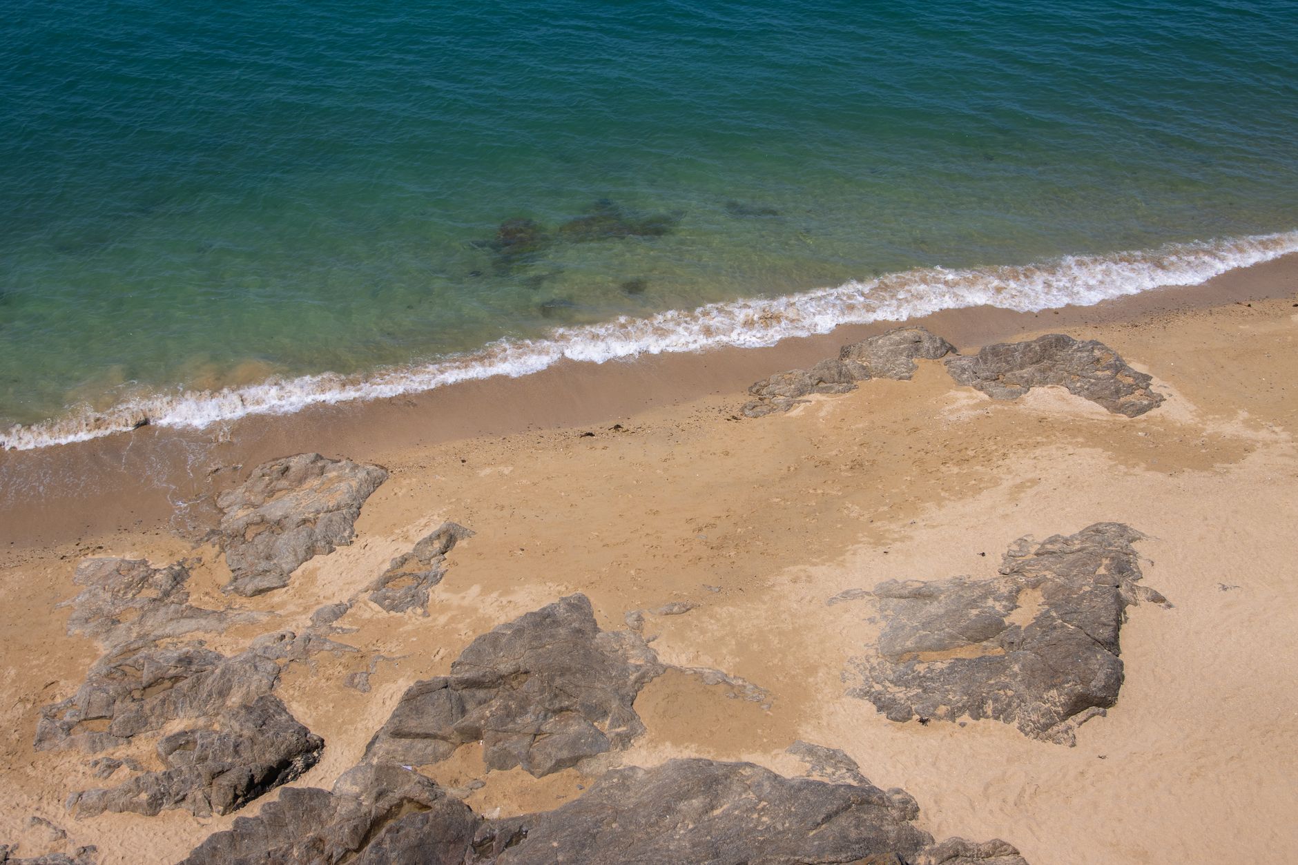 A tranquil sandy beach with rocky formations at Saint-Malo, Brittany, France.