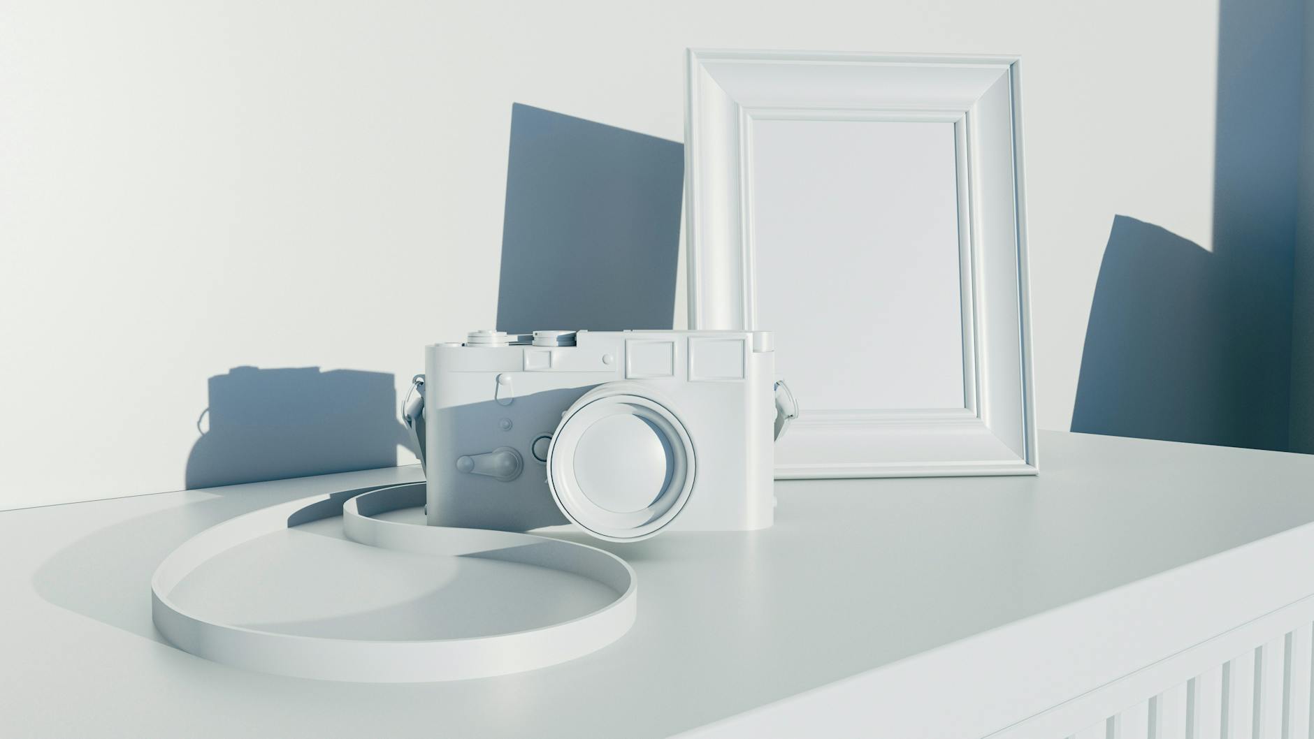 A monochrome camera and frame arranged on a minimalist desk in soft lighting.