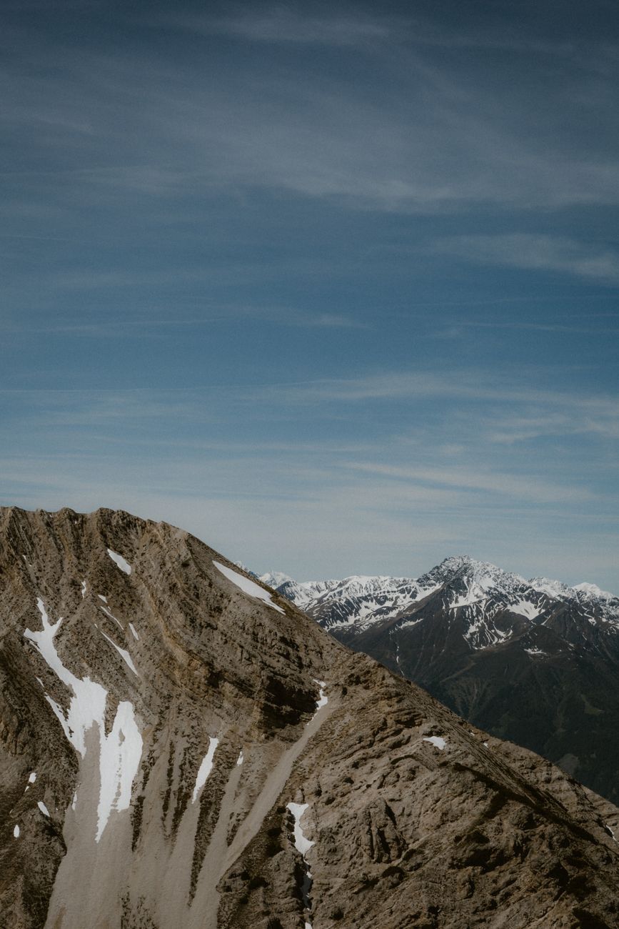 Breathtaking view of rugged, snow-capped mountains under a clear blue sky.